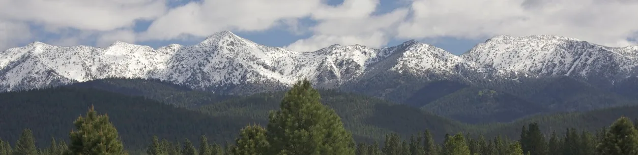 Highway leading to snow-capped mountains near Baker City Oregon
